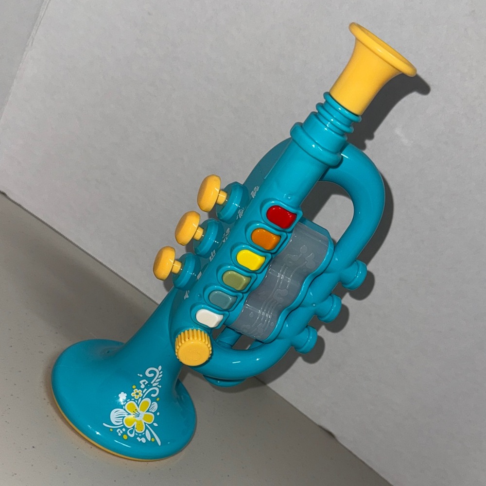 Preschooler trumpet lights and music. Plays upbeat kids songs, or blow do re mi
